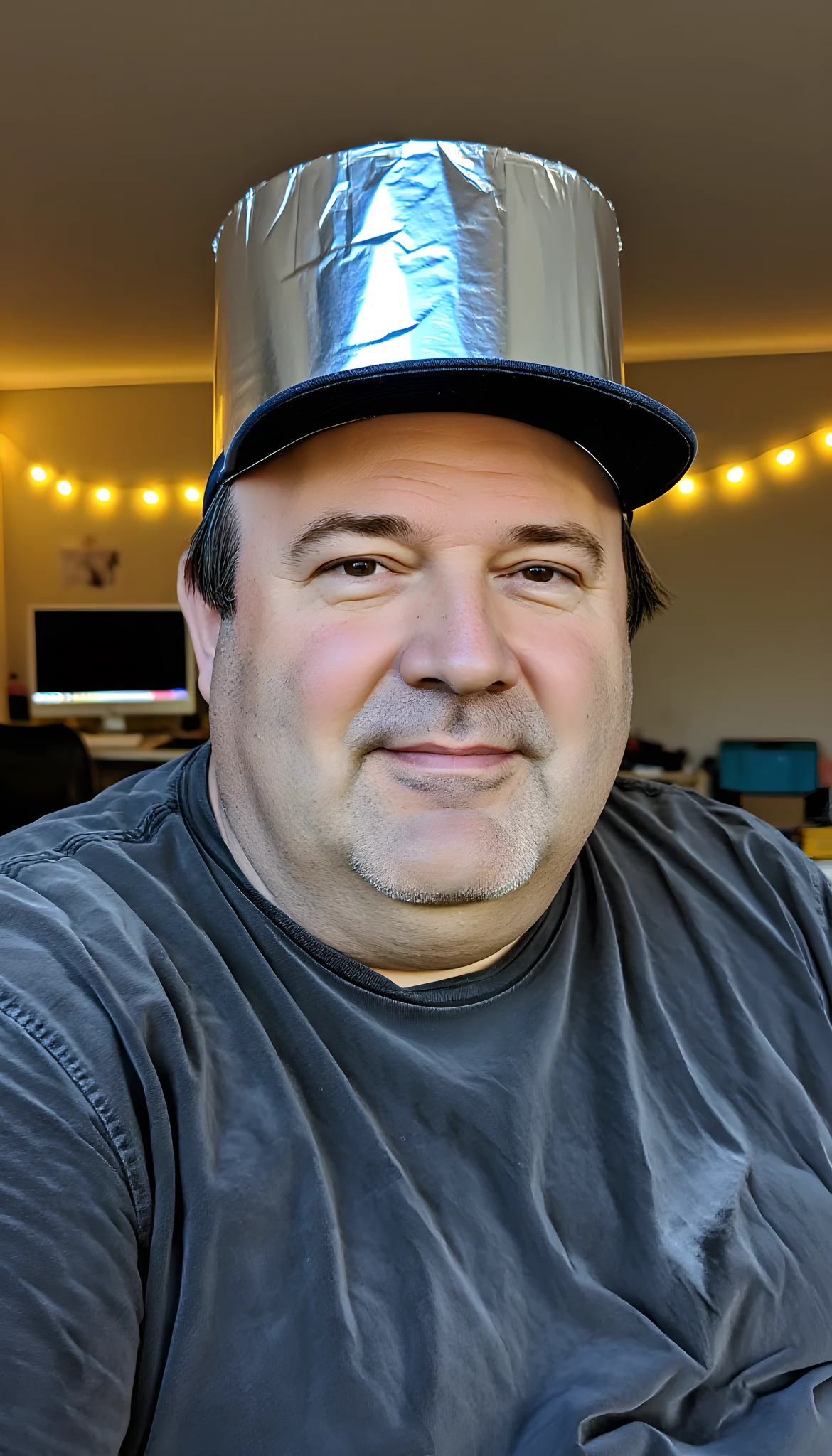Portrait photo of a man. Premium photorealistic portrait, subject sharp, natural realistic color, realistic skin texture, no soft-focus filter, no unwanted oversaturation. A man in his early 50s, balding with a fringe of hair under a baseball cap, overweight. Wearing a wrinkled …